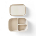 Beige compartmentalized bento box container with lid on a white background