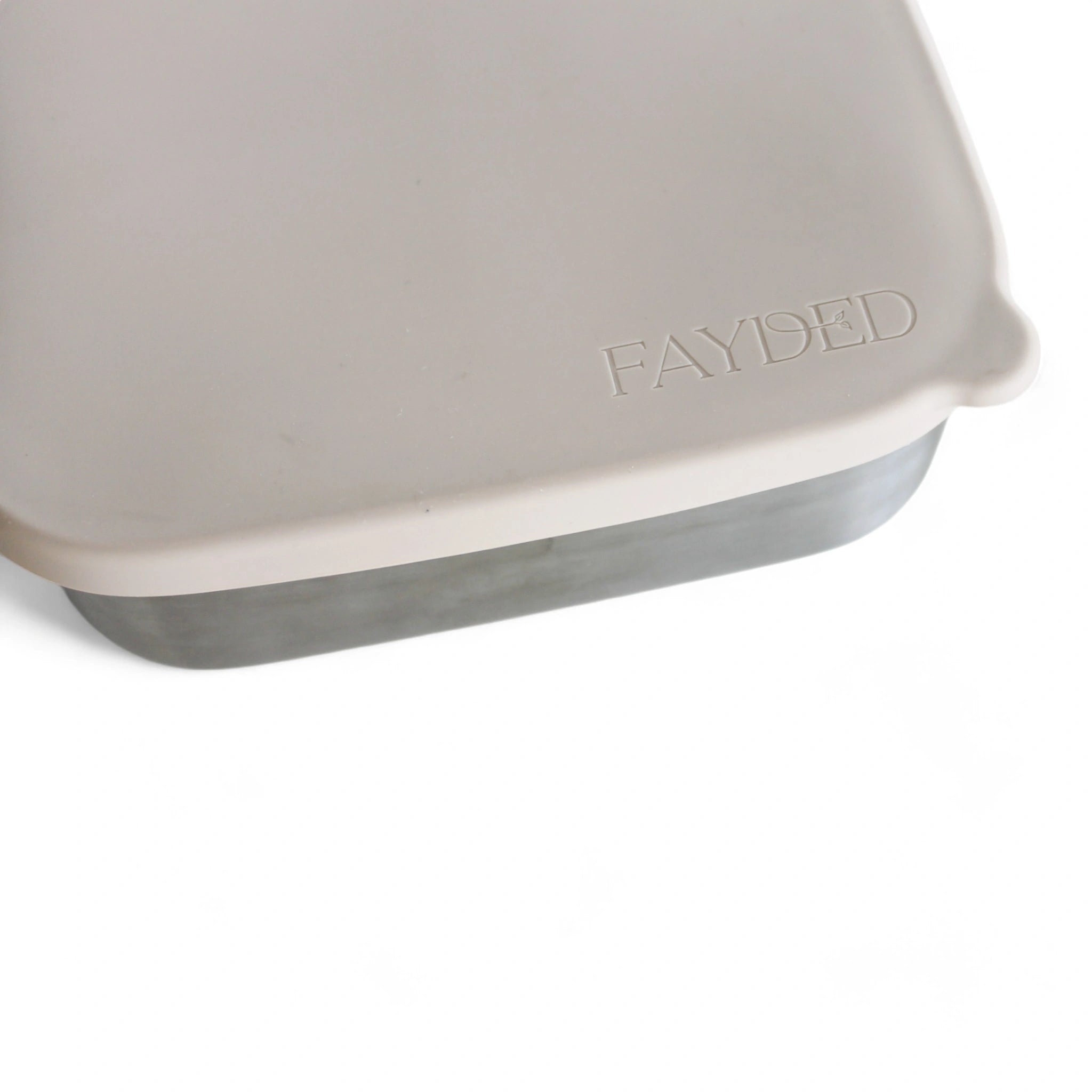Close-up of a beige Silicone and stainless steel bento 'FAYDED' branding on a white background