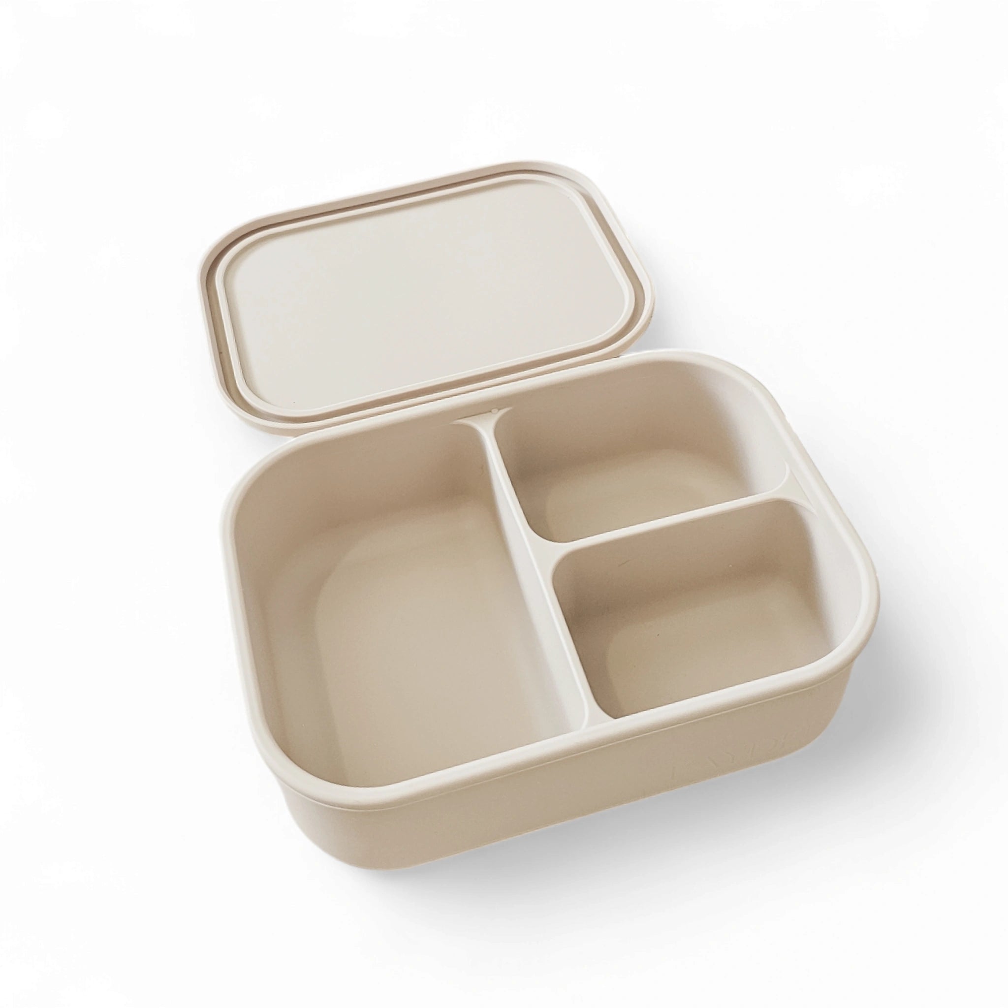 Beige bento box with compartments on a white background