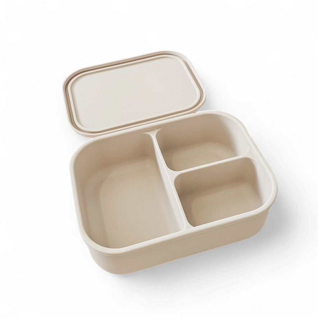 Beige bento box with compartments on a white background