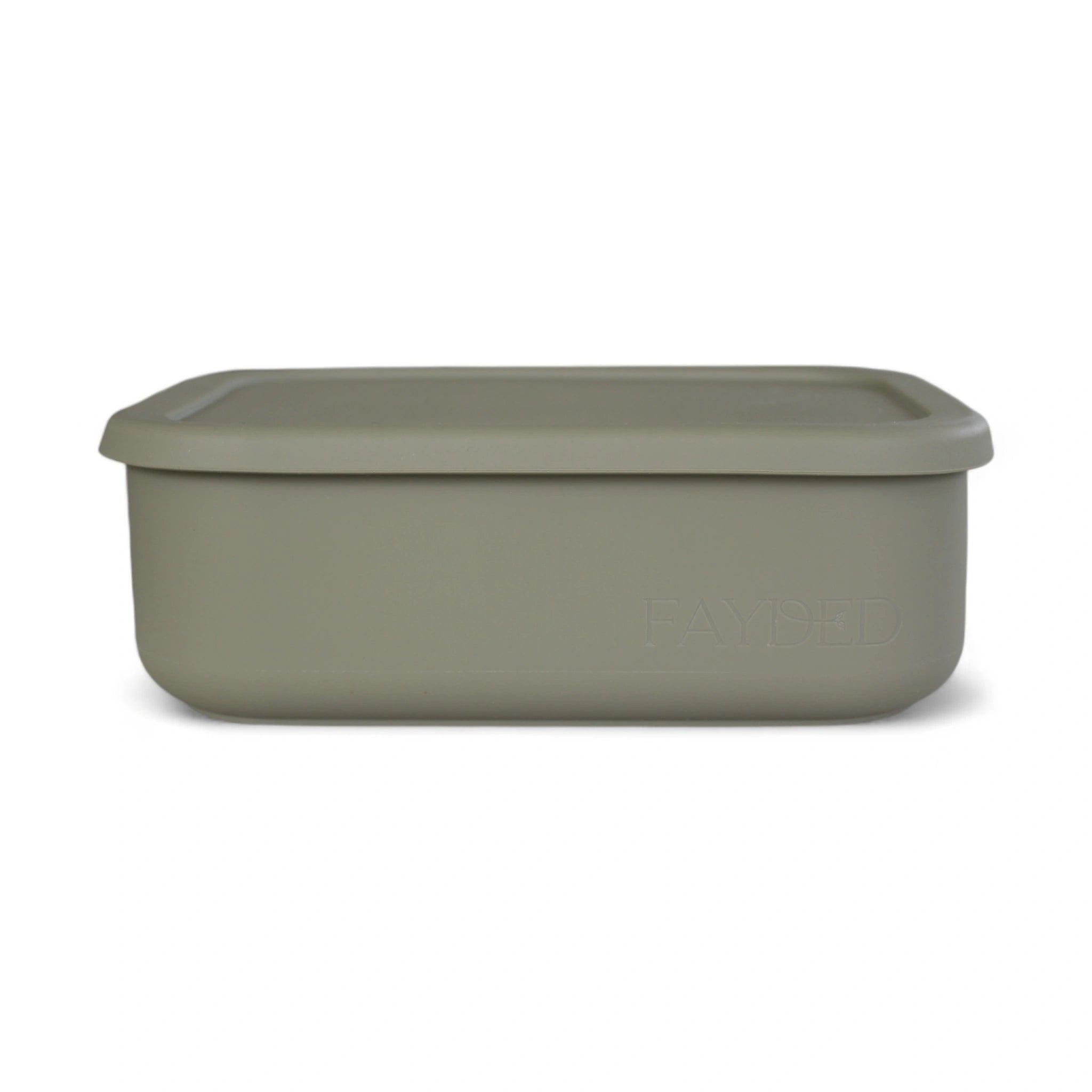 Green storage bento container with lid on a white background