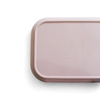 Pink rectangular silicone bento with food safety images on a white background