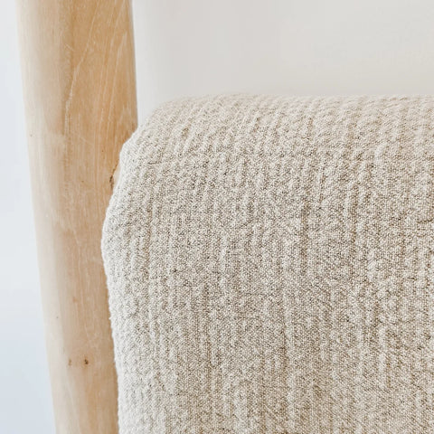 Close-up of a textured natural flax linen fabric on a wooden ladder.