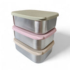 Stack of stainless steel bento box containers with pastel-colored lids on a white background