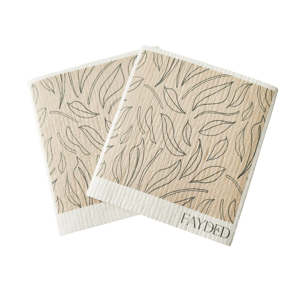 Two beige swedish dishcloths with leaf pattern and 'Fayded' branding on a white background