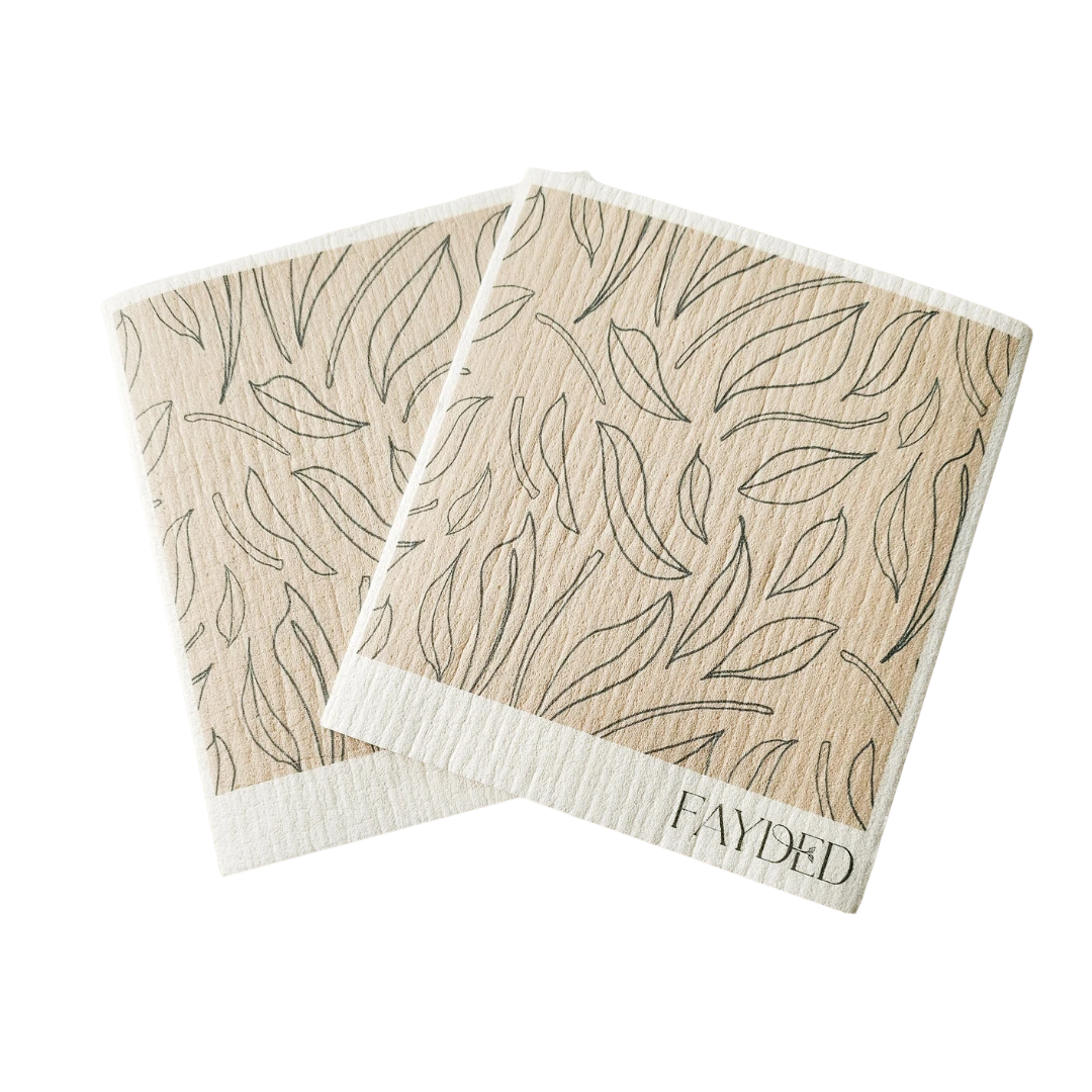 Two beige swedish dishcloths with leaf pattern and 'Fayded' branding on a white background