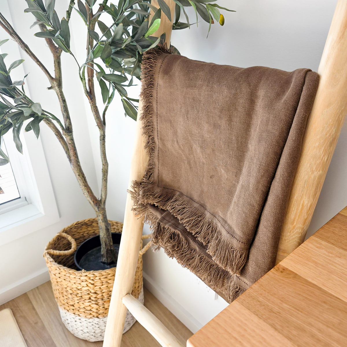 Chocolate brown fringed linen throw blanket draped over wooden ladder – 100% OEKO-TEX® certified linen