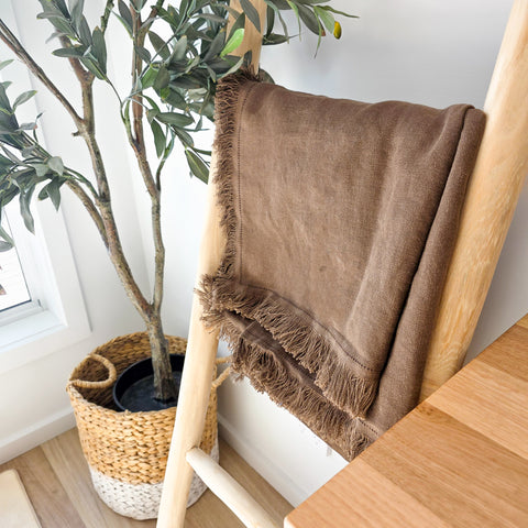 Chocolate brown fringed linen throw blanket draped over wooden ladder – 100% OEKO-TEX® certified linen