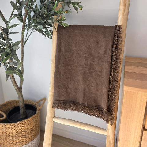 Eco-friendly brown linen blanket on bed – sustainable homeware made from natural fibres